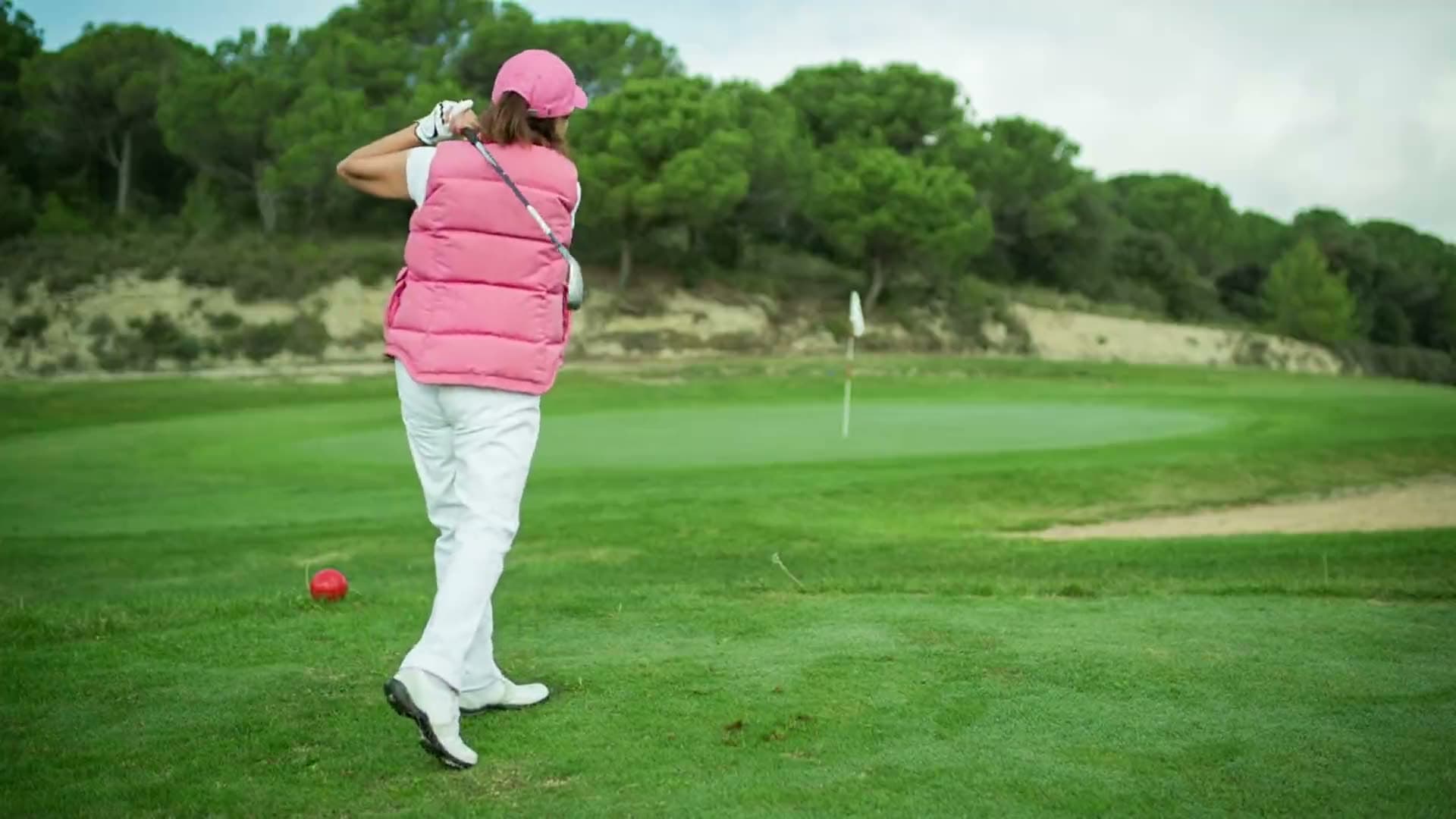 Golfer teeing off on a golf course